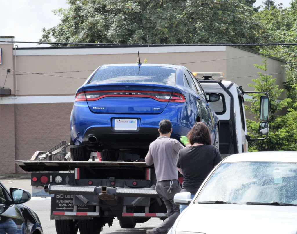 Car being loaded onto a flatbed recovery truck