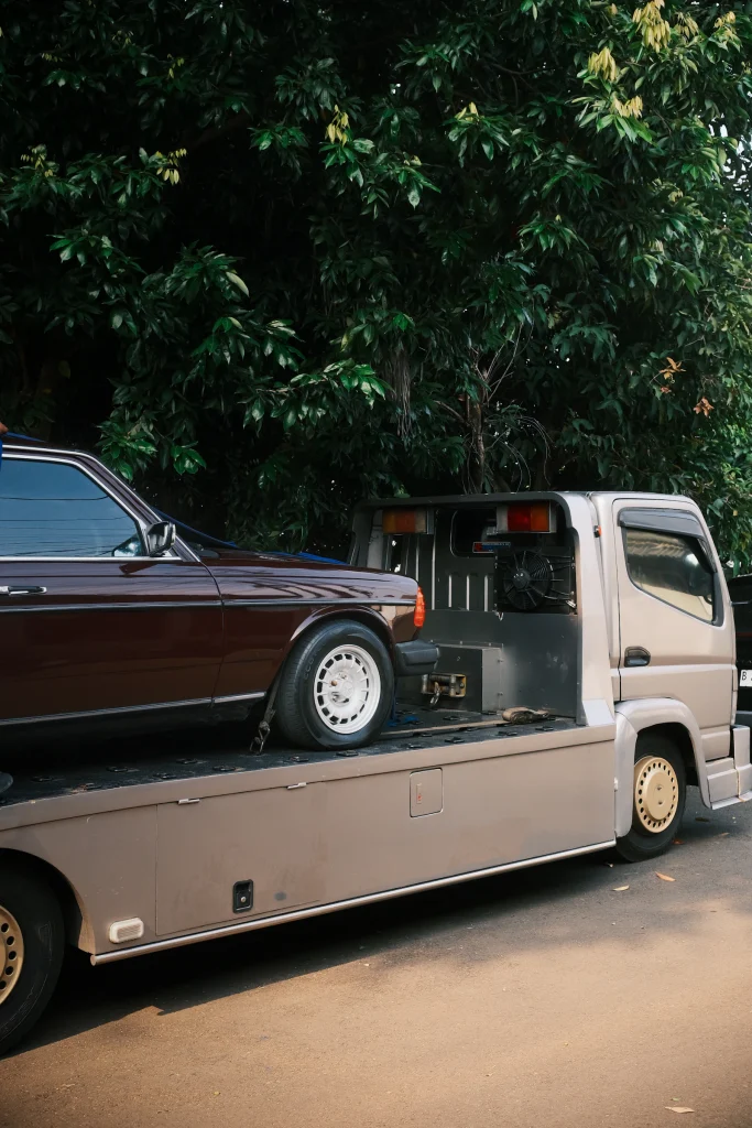 Flatbed truck transporting a car