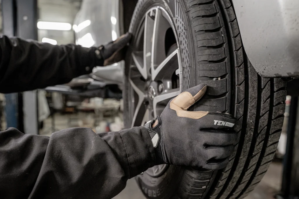Fitter mounting a new tyre on a wheel